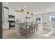 Open concept kitchen with stainless steel appliances, island seating, and a view of the dining area at 7094 Watercress St, Myrtle Beach, SC 29579