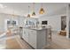 Bright, open kitchen featuring a spacious island, pendant lighting, stainless steel appliances, and adjacent dining area at 7094 Watercress St, Myrtle Beach, SC 29579