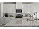 Modern kitchen featuring granite countertops, stainless steel appliances, and white cabinets with a subway tile backsplash at 7094 Watercress St, Myrtle Beach, SC 29579
