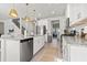 Well-lit kitchen showcases an island, stainless steel appliances, white cabinets, and seamless flow to the living spaces at 7094 Watercress St, Myrtle Beach, SC 29579