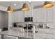 Contemporary kitchen featuring granite countertops, modern lighting, and ample cabinet space at 7094 Watercress St, Myrtle Beach, SC 29579