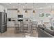Bright, modern kitchen features an island with seating, stainless steel appliances, and an open concept to the living area at 7094 Watercress St, Myrtle Beach, SC 29579