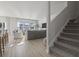 Open-concept living room with a staircase, light wood floors, and many windows at 7094 Watercress St, Myrtle Beach, SC 29579