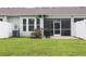 A cozy backyard featuring a screened-in porch and a well-maintained lawn and garden at 797 Salerno Circle # C, Myrtle Beach, SC 29579