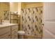 Bathroom with shower-tub combo, leaf-patterned shower curtain, vanity, and modern fixtures at 797 Salerno Circle # C, Myrtle Beach, SC 29579