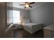 Bright bedroom featuring wood floors, a queen bed, and a ceiling fan at 797 Salerno Circle # C, Myrtle Beach, SC 29579