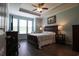 Bedroom features tray ceiling, ceiling fan, and a wall of windows at 797 Salerno Circle # C, Myrtle Beach, SC 29579