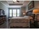 Comfortable bedroom with wood floors, tray ceiling, and ceiling fan at 797 Salerno Circle # C, Myrtle Beach, SC 29579