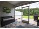 Inviting screened porch with outdoor seating, a lush green view, and a cozy atmosphere at 797 Salerno Circle # C, Myrtle Beach, SC 29579