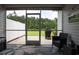 Screened patio with view of backyard and grill; stylish rug and furniture enhance outdoor living at 797 Salerno Circle # C, Myrtle Beach, SC 29579