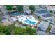 Aerial view of a community pool featuring a pool, spa, pond, and lounge chairs at 820 9Th Ave. S, North Myrtle Beach, SC 29582