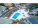 Aerial view of a community pool with lounge chairs, surrounded by well-manicured landscaping and homes at 820 9Th Ave. S, North Myrtle Beach, SC 29582
