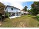 Lush backyard with a house featuring two decks, a covered patio, and a spacious lawn at 820 9Th Ave. S, North Myrtle Beach, SC 29582