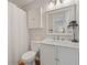 Bright bathroom with a marble vanity, shuttered cabinet, white fixtures, and a framed mirror at 820 9Th Ave. S, North Myrtle Beach, SC 29582