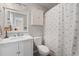 Well-lit bathroom featuring a vanity with a marble countertop, a toilet, and a shower with a nautical curtain at 820 9Th Ave. S, North Myrtle Beach, SC 29582