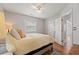 Inviting bedroom with a ceiling fan, natural light, wood flooring, and a comfortable bed at 820 9Th Ave. S, North Myrtle Beach, SC 29582