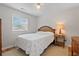 Cozy bedroom with a wicker headboard, ceiling fan, natural light, and wood flooring at 820 9Th Ave. S, North Myrtle Beach, SC 29582