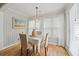 Inviting dining room featuring wood floors, bright natural light, coastal decor, and a modern light fixture at 820 9Th Ave. S, North Myrtle Beach, SC 29582