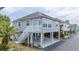 Inviting coastal home featuring a raised structure, stairs, and well-maintained landscaping for charm at 820 9Th Ave. S, North Myrtle Beach, SC 29582