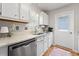 Bright kitchen featuring white cabinets, stainless steel appliances, granite countertops, and a window over the sink at 820 9Th Ave. S, North Myrtle Beach, SC 29582