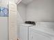 Simple laundry room featuring a white washer and dryer with a classic design and a blue painting at 820 9Th Ave. S, North Myrtle Beach, SC 29582