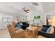 Spacious living room with comfortable seating, a ceiling fan, wood flooring, and plenty of natural light at 820 9Th Ave. S, North Myrtle Beach, SC 29582