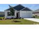 Charming single-story home with a well-manicured lawn and attached two-car garage at 857 Farmers Passage Loop, Loris, SC 29569