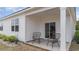Cozy covered patio with comfortable chairs and a sliding glass door leading inside at 857 Farmers Passage Loop, Loris, SC 29569