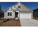 Charming single-Gathering home featuring a 1-car garage, landscaped yard, and classic architectural details at 869 Farmers Passage Loop, Loris, SC 29569