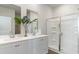 This bright bathroom features double sinks, white cabinets, and a glass-enclosed shower at 877 Farmers Passage Loop, Loris, SC 29569
