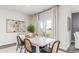 Open-concept dining area with stylish decor and natural light from a sliding glass door at 877 Farmers Passage Loop, Loris, SC 29569