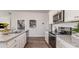 This kitchen features white cabinets, granite countertops, and stainless steel appliances at 877 Farmers Passage Loop, Loris, SC 29569
