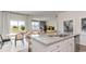 A spacious kitchen island overlooks the dining area and living room in this bright and airy home at 877 Farmers Passage Loop, Loris, SC 29569