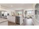 Bright kitchen with white cabinets, stainless steel appliances, and an open floor plan to the living room at 877 Farmers Passage Loop, Loris, SC 29569