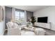 Bright living room with blue accent wall, lots of natural light, and stylish furniture at 877 Farmers Passage Loop, Loris, SC 29569