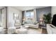 Comfortable living room with large windows, neutral colors, and stylish furniture at 877 Farmers Passage Loop, Loris, SC 29569