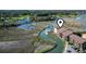 Overhead capture highlighting the condo building's riverside setting, flanked by a serene waterway and green spaces at 9501 Shore Dr. # A-311, Myrtle Beach, SC 29572