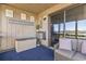 Cozy screened-in porch features seating, decor, and golf course views at 9501 Shore Dr. # A-311, Myrtle Beach, SC 29572