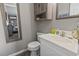 Cozy bathroom with a neutral palette, vanity, toilet, and a framed mirror at 9501 Shore Dr. # A-311, Myrtle Beach, SC 29572