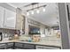 Bright kitchen showcases modern lighting fixture, countertops, sink, and 