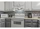 Bright kitchen features white appliances, sleek countertop appliances and stylish mosaic backsplash at 9501 Shore Dr. # A-311, Myrtle Beach, SC 29572