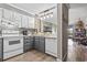 Cozy kitchen featuring white appliances, gray cabinets, and beach-themed decor for a relaxing coastal vibe at 9501 Shore Dr. # A-311, Myrtle Beach, SC 29572