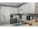 Well-lit kitchen featuring stainless steel appliances, sleek countertops, and stylish mosaic backsplash at 9501 Shore Dr. # A-311, Myrtle Beach, SC 29572