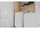 Functional laundry room featuring a washer, dryer, and shelving for storage at 9501 Shore Dr. # A-311, Myrtle Beach, SC 29572