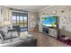 Inviting living room with gray couch, stylish TV, and sliding glass doors to the balcony at 9501 Shore Dr. # A-311, Myrtle Beach, SC 29572