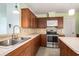Well-lit kitchen with stainless steel appliances and neutral countertops, creating a functional cooking space at 1001 Greencrest Ct., Conway, SC 29526