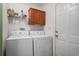 Practical laundry area with machines, storage, and exterior access door at 1001 Greencrest Ct., Conway, SC 29526