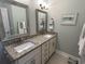 Well-lit bathroom featuring a double vanity with granite countertops and modern fixtures at 1029 Ray Costin Way # Villa 909, Murrells Inlet, SC 29576