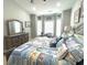 Relaxing bedroom with queen bed, dresser, and bay window seating area at 1029 Ray Costin Way # Villa 909, Murrells Inlet, SC 29576