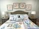 Comfortable bedroom features a queen bed, nautical decor, and calming color scheme at 1029 Ray Costin Way # Villa 909, Murrells Inlet, SC 29576